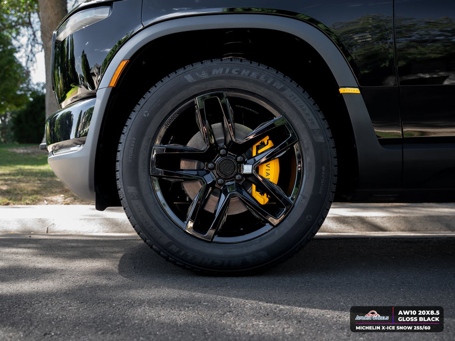 Front wheel close-up of Rivian R2 with gloss black AW10 20x8.5 forged wheels and Michelin X-ICE SNOW 255/60 tires
