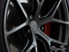 AW center cap and Titan wheel finish close-up of red Tesla Model S Long Range with titan AWZZ forged wheels, 19x9.5 front and 19x10.5 rear, and Michelin Pilot Sport All Season 4 tires