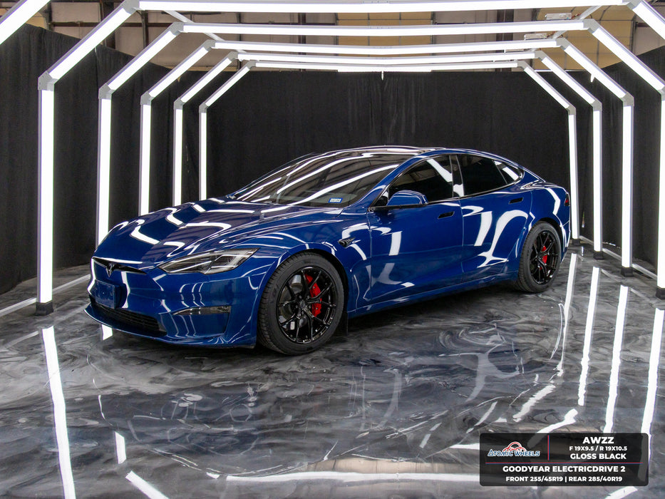 Front three-quarter view of blue Tesla Model S Plaid with gloss black AWZZ forged wheels, 19x9.5 front and 19x10.5 rear, and Goodyear ElectricDrive 2 tires