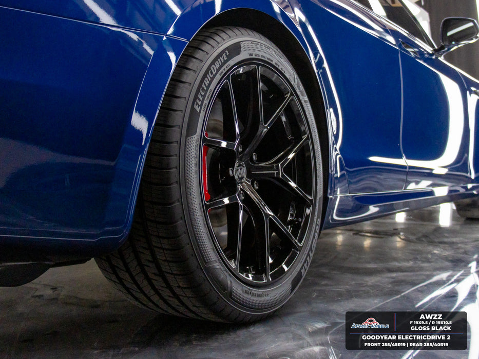 Rear wheel and side view of blue Tesla Model S Plaid with gloss black AWZZ forged wheels, 19x9.5 front and 19x10.5 rear, and Goodyear ElectricDrive 2 tires