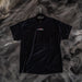 Black t-shirt with a logo on a hanger against a textured gray background