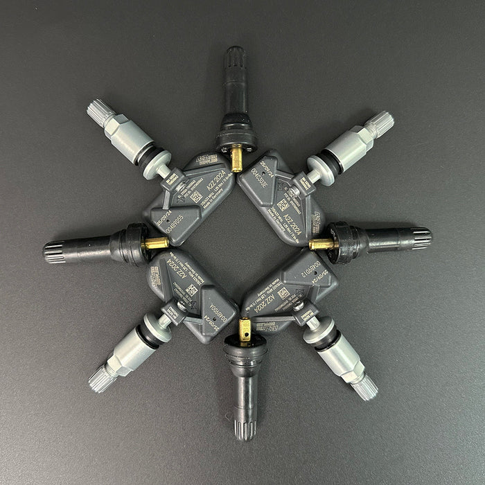 Set of tire pressure monitoring system (TPMS) sensors on a gray background